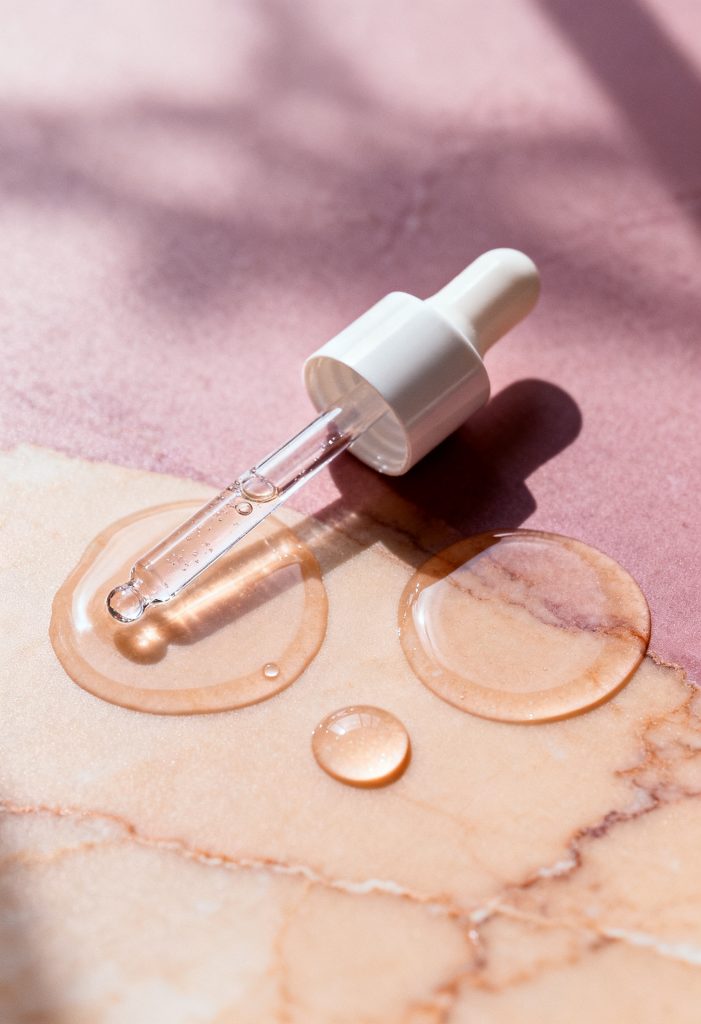 Paula's Choice 2% BHA Liquid Exfoliant bottle with skincare texture background